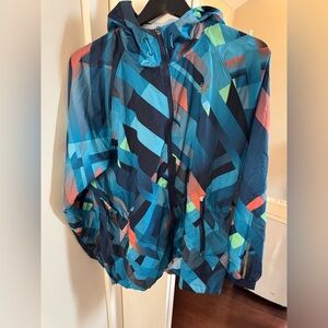 New Balance EUC women’s Geometric Hooded Rain Jacket with Neon Accents